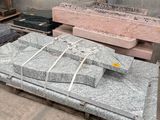 a pile of grey granite blocks on a pallet