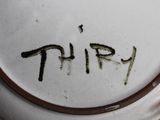 a close up of a plate with the word thr written on it