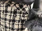 a close up of a woman ' s skirt with a black and white pattern