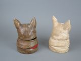 two ceramic animals sitting next to each other on a table