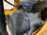 a black blower sitting on top of a yellow machine