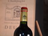 a bottle of wine sitting on a table next to a book