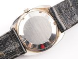 a close up of a watch on a white surface