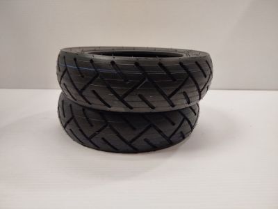 two black tires stacked on top of each other on a table