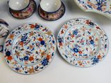 many plates and cups and bowls on the table