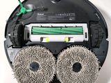 an image of a robotic vacuum cleaner with two wheels and a brush