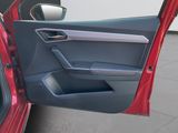 a red car with the door open on the side of the road