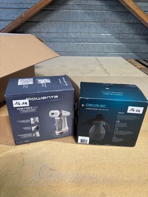 two boxes of coffee machines sitting on top of a cardboard box