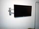 un téléviseur à écran plat fixé au mur d'une pièce