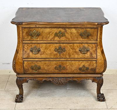 an antique chest of drawers with a marble top on a tiled floor
