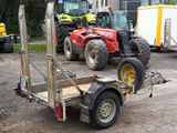 a trailer with a tractor attached to it in a parking lot