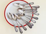 a lot of spoons arranged in a circle on a plate