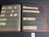 an open book with stamps on it sitting on top of a table