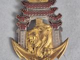 an image of a gold and red brooch with a lion on it