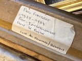 a hand holding a piece of wood with a label on it