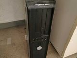 a black computer sitting on the floor next to a wall