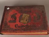 an old book with a red cover and a picture of a cat