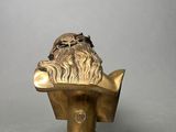 an old bronze bust of a man with a beard on a pedestal
