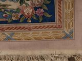 a picture of a rug with flowers and birds on it