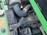 a close up view of a tractor engine with a green cover