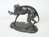bronze statue of a dog running on a base on a white background