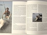 an open book with a picture of a man holding a fish