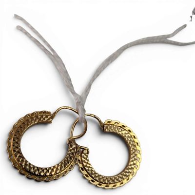 pair of gold hoop earrings on a white background with a ribbon