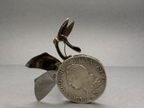 a silver coin with a bird on top of it