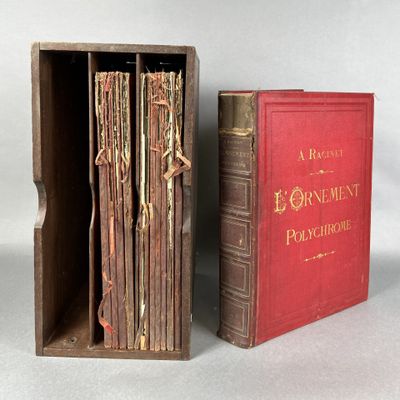 two books in a wooden box sitting next to each other on a table