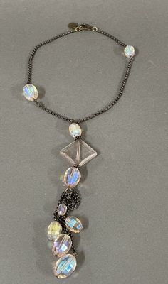 a close up of a necklace on a table with a chain