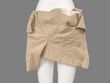 a white mannequin torso with a tan skirt and a brown belt