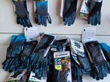 Plusieurs paires de gants de jardinage sont accrochées au mur.