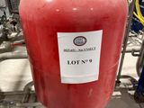 a red tank that has a lot of red liquid on it