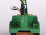 a green toy truck with a man in the back