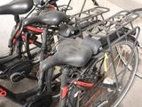 many bikes that are parked in a parking lot