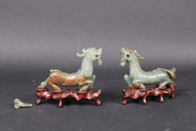pair of green and brown figurines of two animals on a tree branch