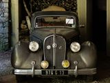 a old car that is parked in a garage