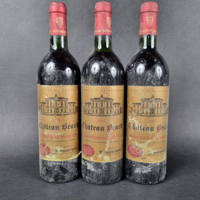 three bottles of wine sitting on top of a table next to each other