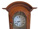 a wooden clock with roman numerals on the face