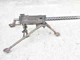 a machine gun that is sitting on a tripod