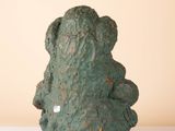 a green statue of a bear sitting on a table