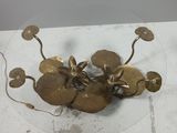 a glass plate with some gold flowers on it