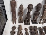 a lot of wooden figurines that are sitting on a table