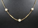 a gold necklace with pearls on a mannequin mannequin mannequin mannequin mannequin mannequin mannequin mannequin mann