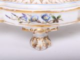 a white bowl with blue and yellow flowers on it