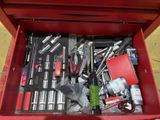 a red tool box full of tools on the floor