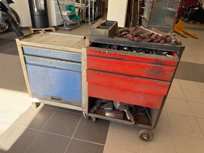 a red and blue work cart in a garage