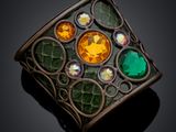 an image of a green and yellow broochle broochle on a black surface