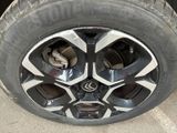 the rim of a car with a tire on it ' s side
