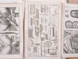 three pages of drawings on a table that are on display
